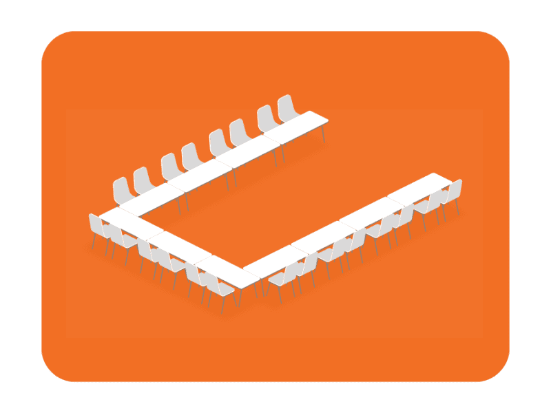 Image showing U-shaped seating arrangement with tables set up in a U form facing a presenter, facilitating engagement and discussion.
